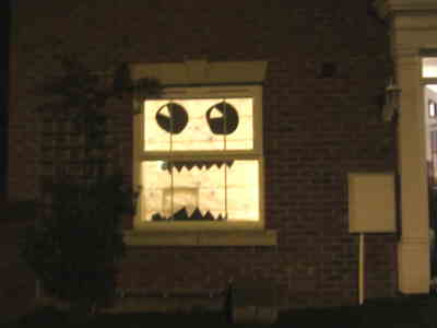 pizza box based silhouettes make monster face in window at night with back lighting