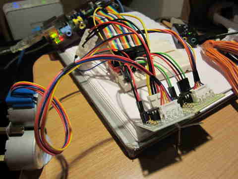 Boards and wires connecting two stepper motors to a Raspberry Pi
